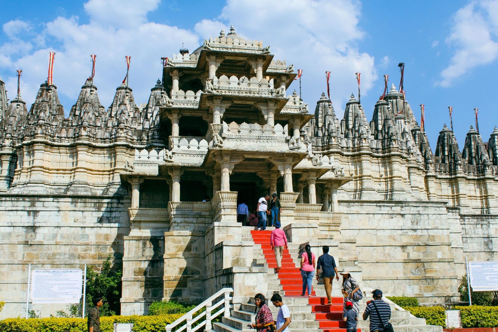 Explore the stunning architecture of the Ranakpur Jain Temple in Sadri, India, under a bright blue sky.