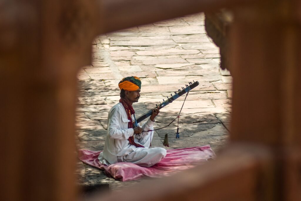 A Rajasthani musician performs outdoors with a traditional instrument in Jodhpur, India.