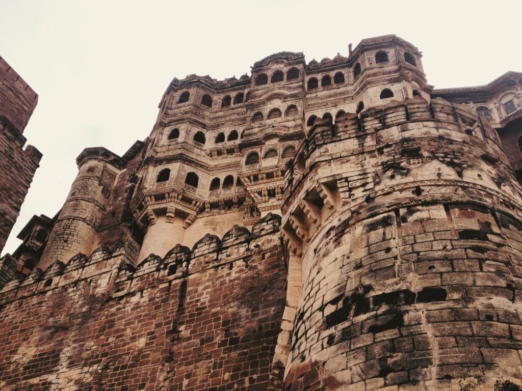 Low-angle shot of the historic Mehrangarh Fort in Jodhpur, showcasing its intricate architectural design.